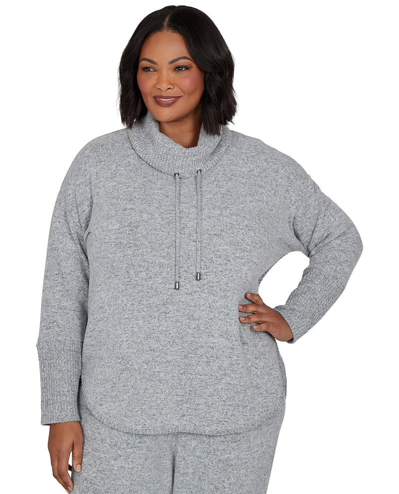 Woman wearing a gray cowl neck sweater on a white background
