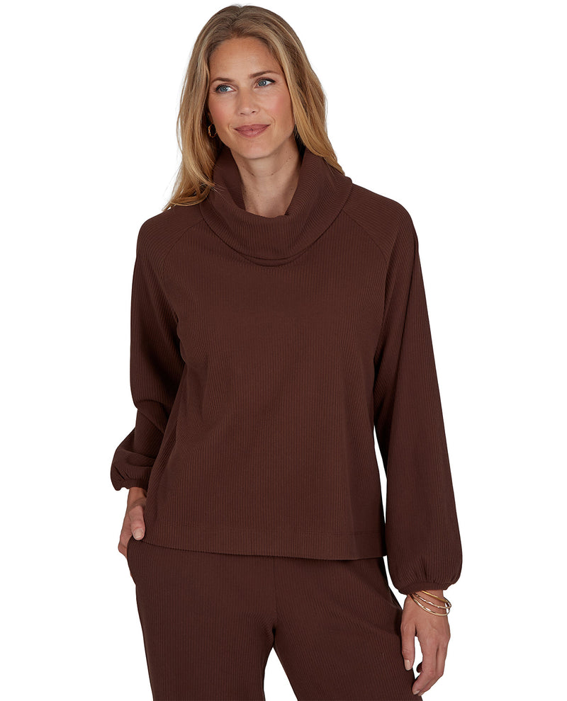 Woman wearing a petite brown cowl-neck top and pants on a white background