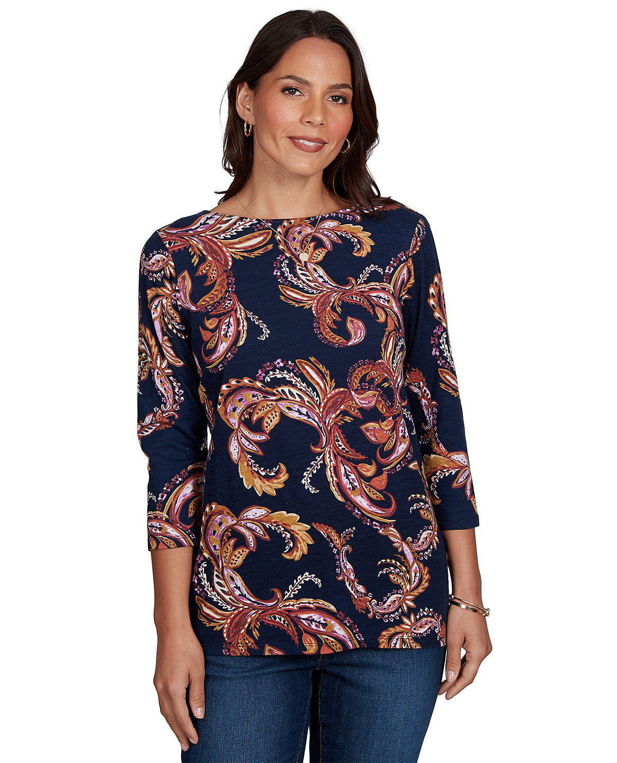 Woman wearing a navy blue top with intricate paisley pattern on a white background