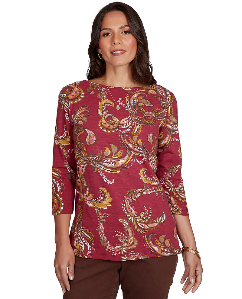 Woman wearing a red patterned top on a white background