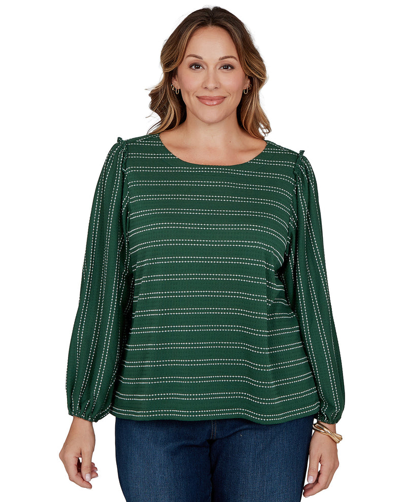 Woman wearing a green patterned blouse on a white background