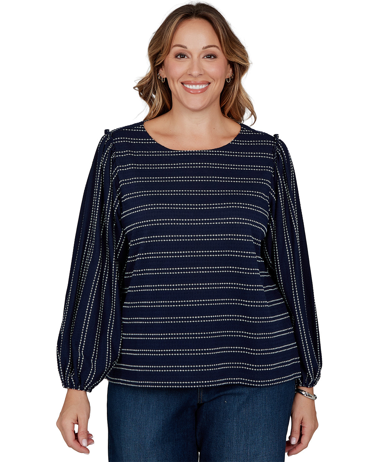 Woman wearing a navy blue top with white patterns on a white background