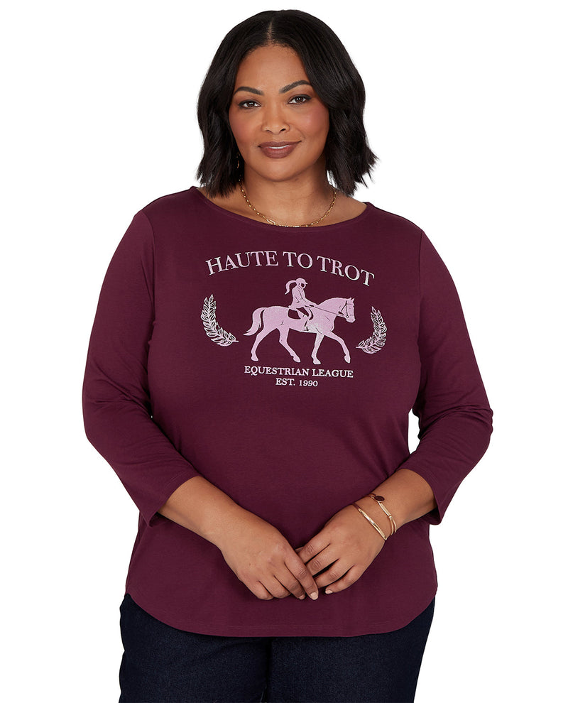 Woman wearing a maroon sweatshirt with equestrian design and text on a white background