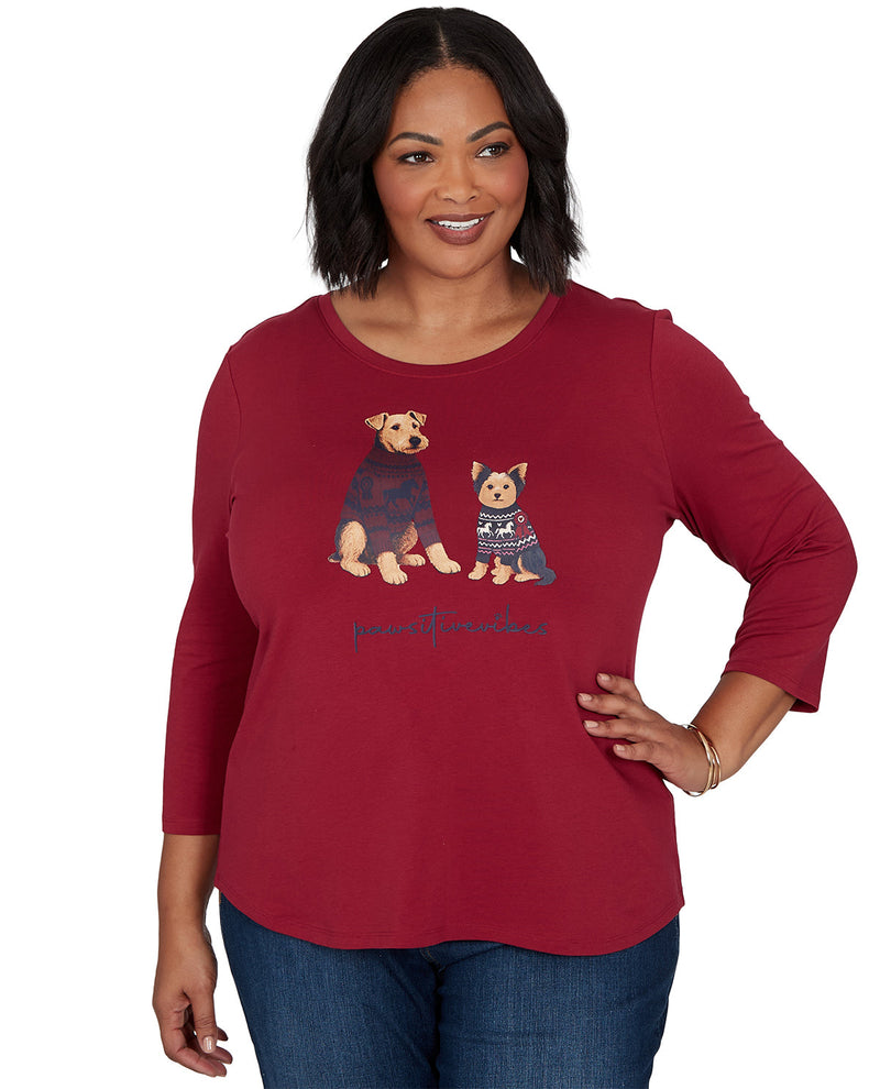 Woman wearing a red long-sleeve shirt with dog illustrations on a white background