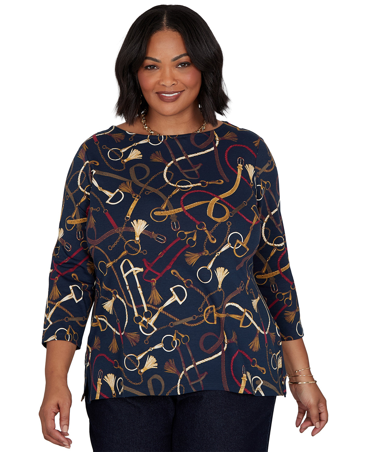 Woman wearing a navy blue top with equestrian pattern on a white background