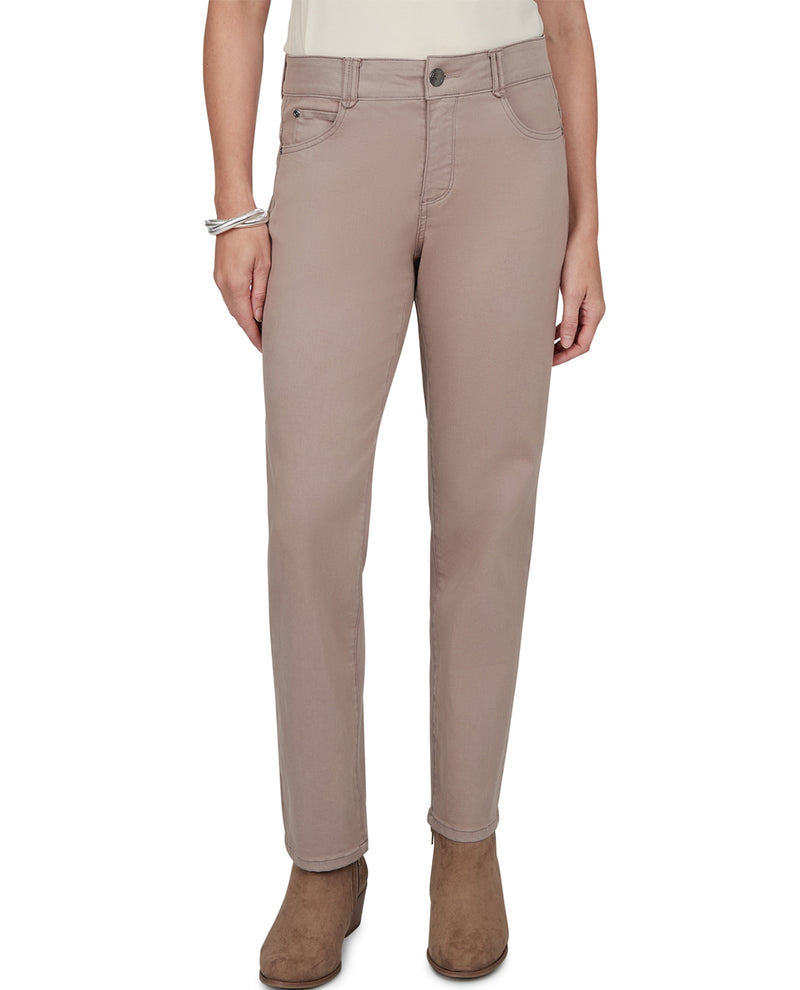 A model wearing a pair of slim-fit, straight-leg jeans in a muted taupe-beige color, paired with brown suede ankle boots against a plain white background.