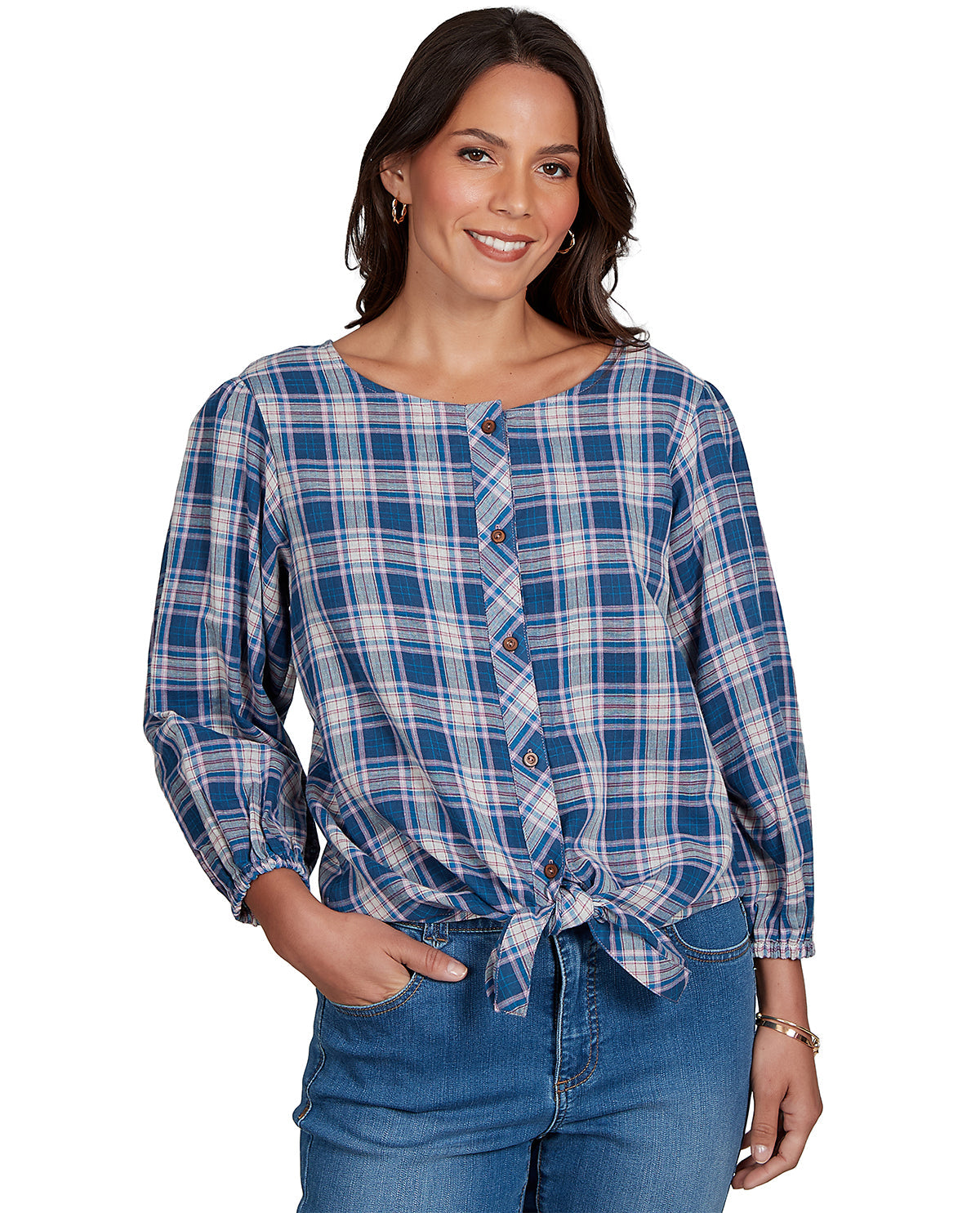 Woman wearing a blue plaid shirt and jeans on a white background