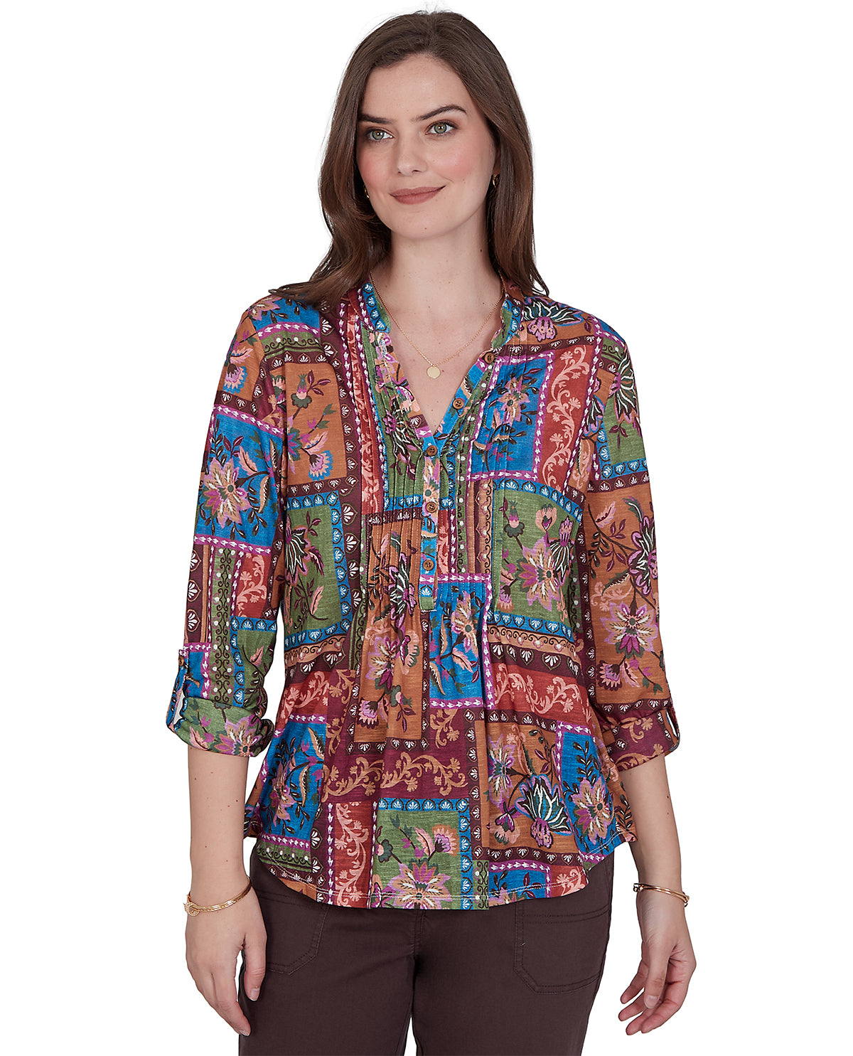 Woman wearing a colorful patterned blouse on a white background