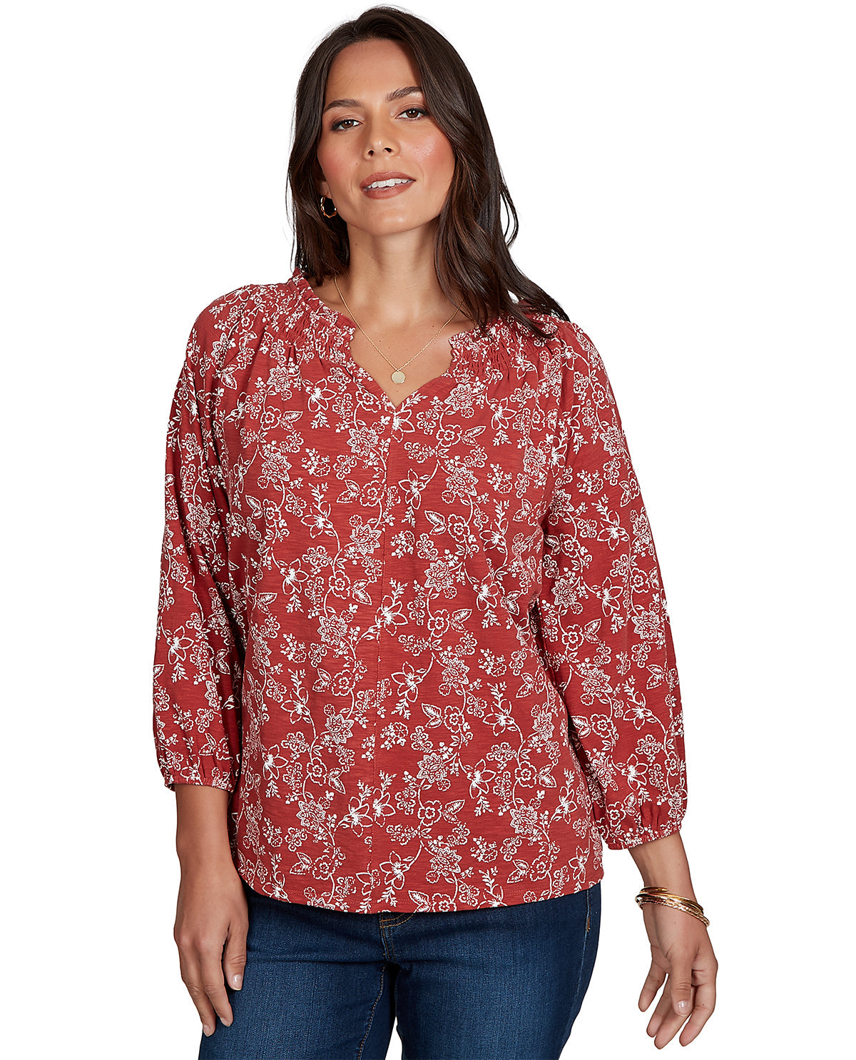 Woman wearing a red floral blouse on a white background