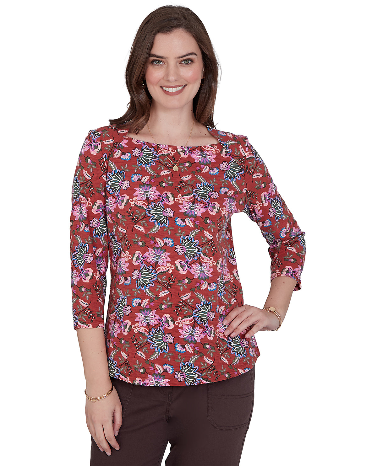 Woman wearing a red floral patterned blouse on a white background