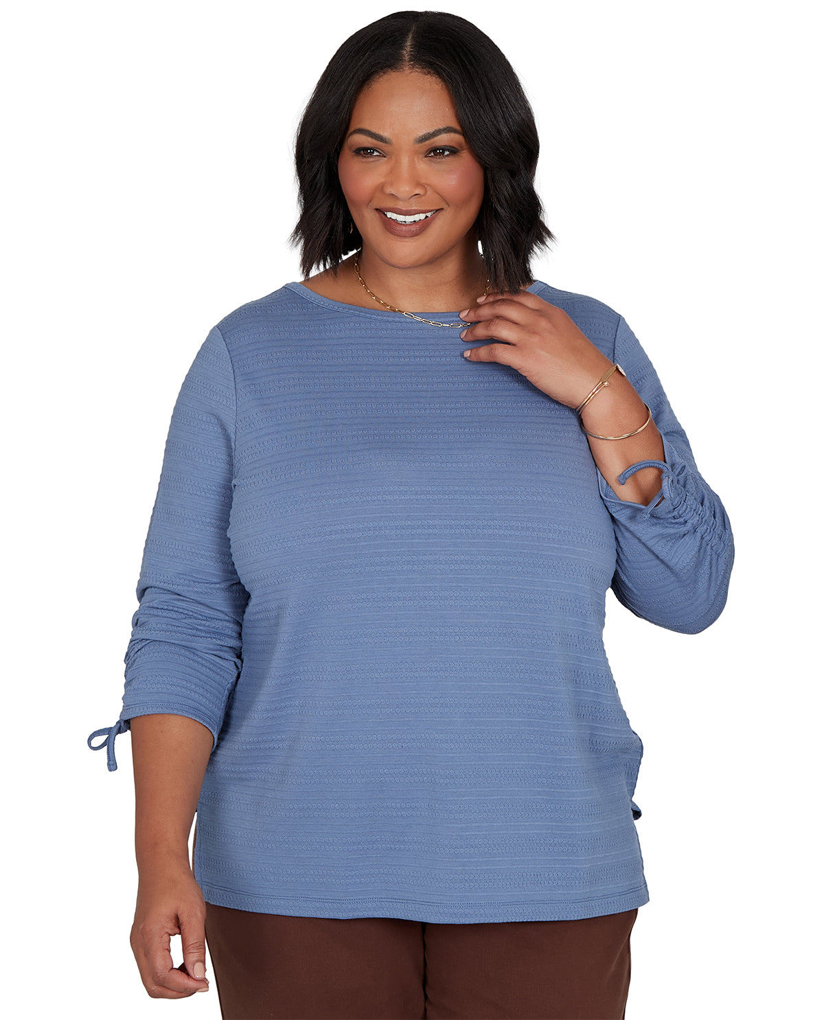 Woman wearing a blue long-sleeve top on a white background