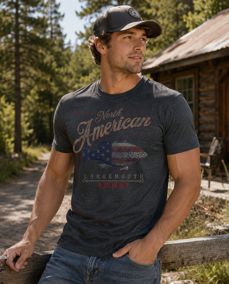 Man wearing a dark blue t-shirt with 'North American Largemouth' graphic in a forest setting.
