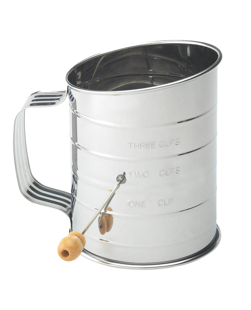 Metal measuring cup with wooden handle on a white background