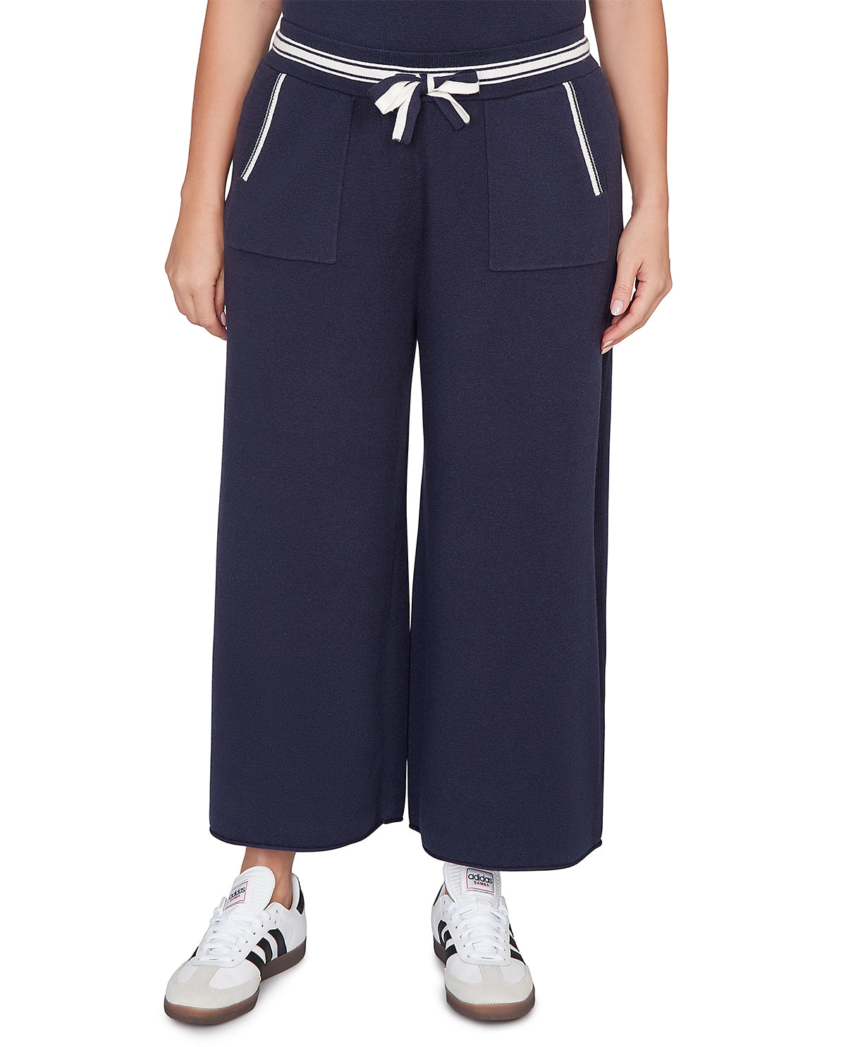 Navy wide-leg pants with white trim worn by a person on a white background