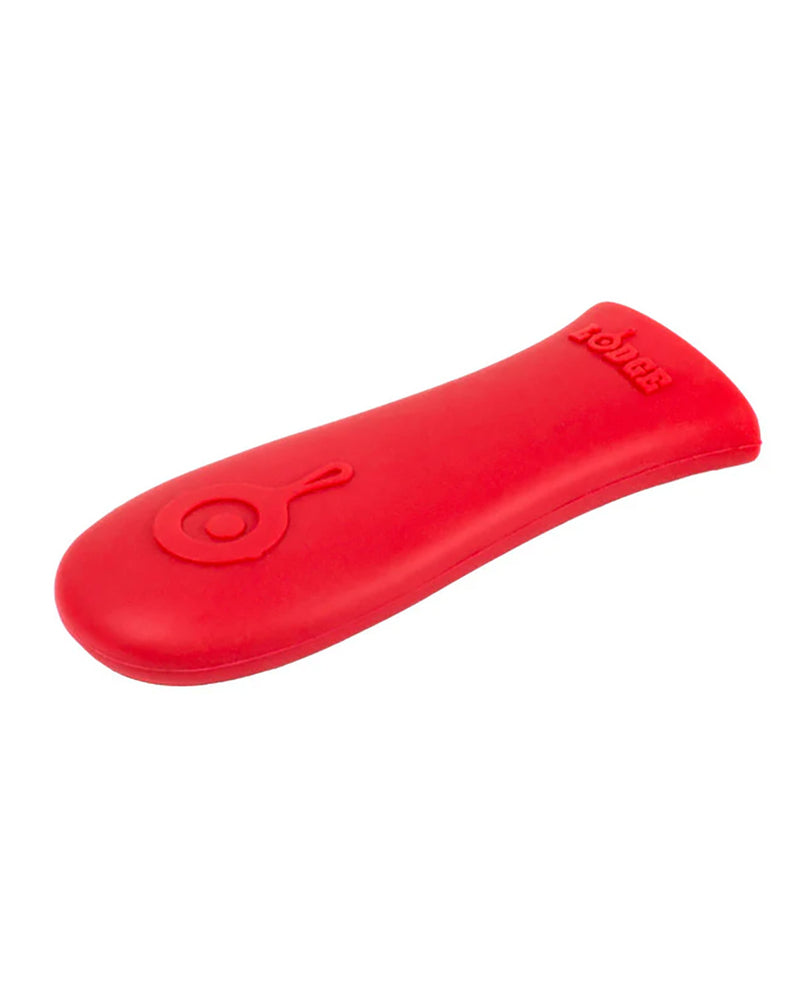 A red silicone dog chew toy with a textured oval design and embossed brand logo, shown on a plain white background.