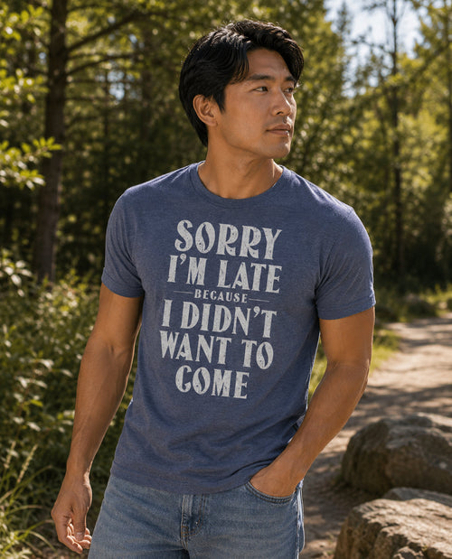 Man wearing a blue t-shirt with text in a forest setting