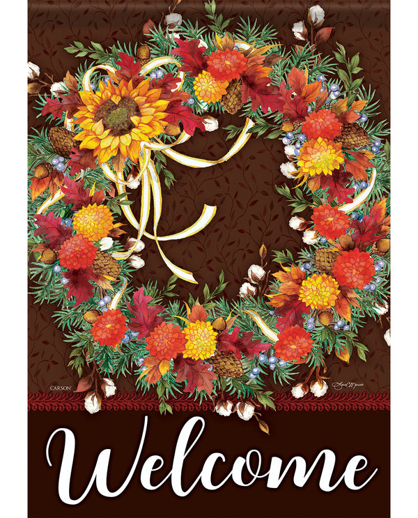 Decorative wreath with autumnal elements and the word 'Welcome' on a brown background