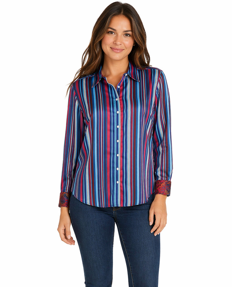Woman wearing a colorful striped shirt and jeans on a white background