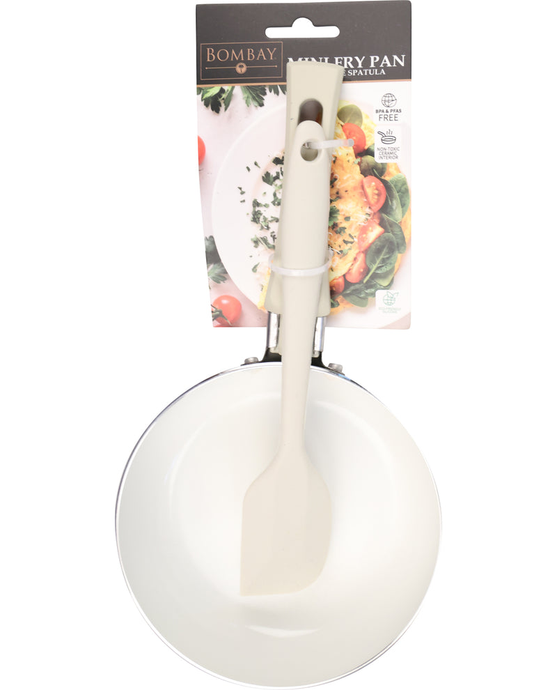 White frying pan with spatula on a white background, featuring Bombay Trading Co packaging.