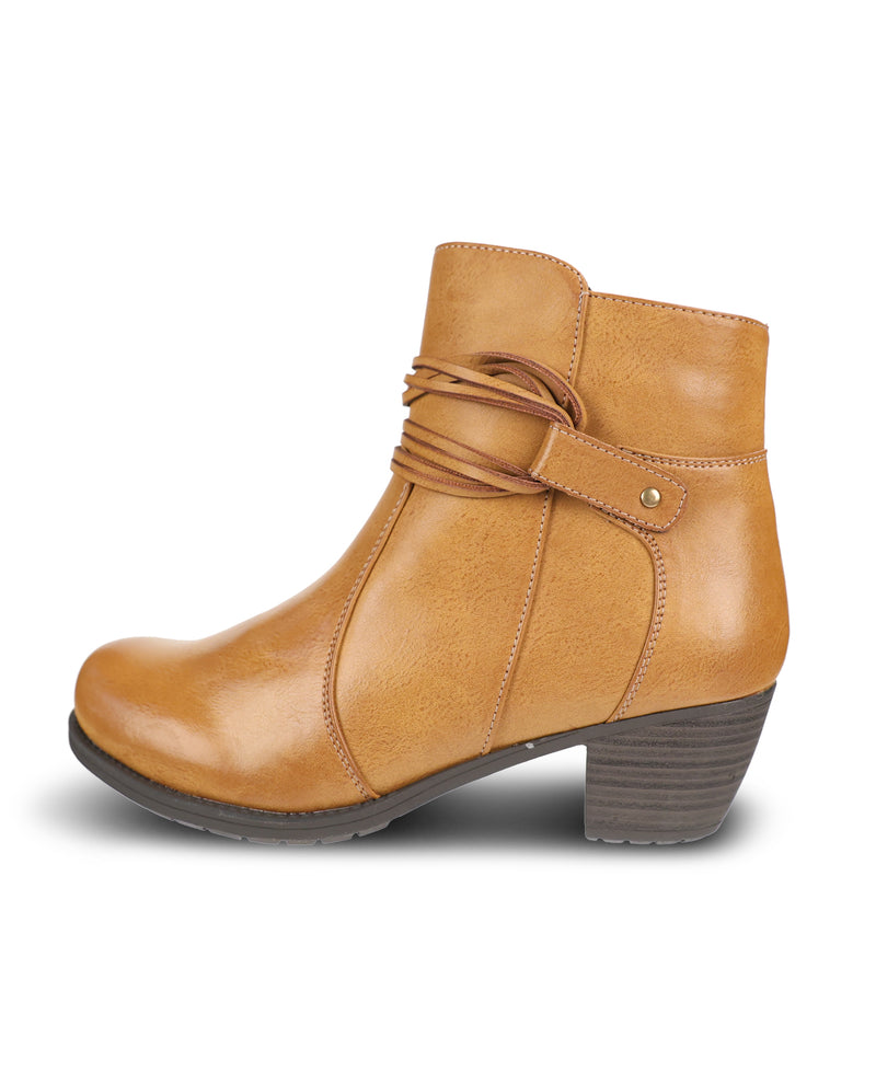 A tan faux-leather ankle boot with a low block heel, decorative side strap, and a small gold-tone rivet, shown from a side profile on a white background.