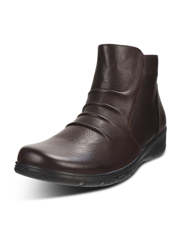 A dark brown leather ankle boot with a low wedge heel and a textured sole, shown from a three-quarters angle on a white background.