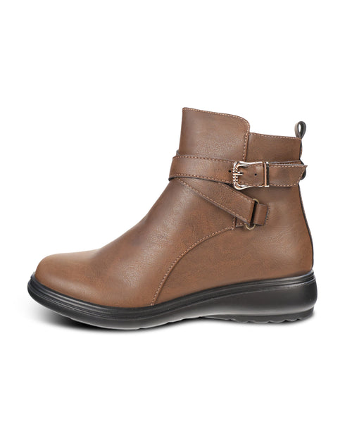 A brown faux-leather ankle boot with a black wedge sole and a decorative buckle strap around the ankle, shown from a side profile on a white background.