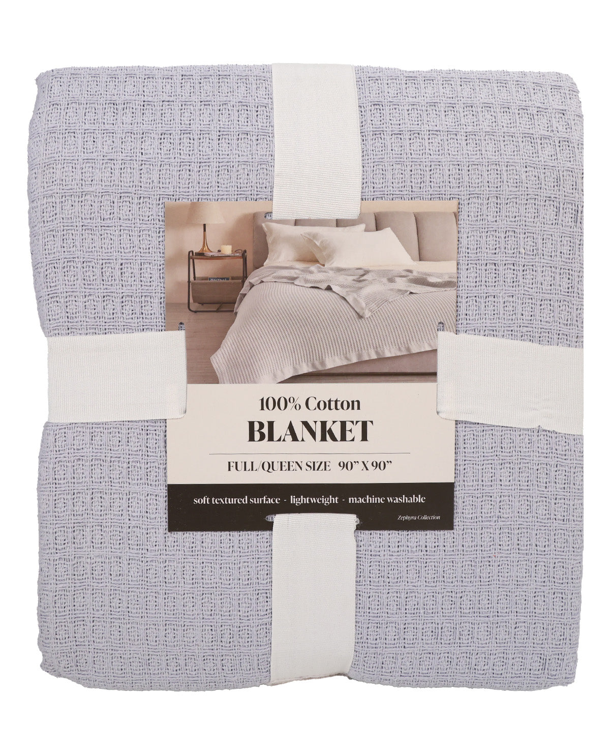 A folded light gray textured cotton blanket wrapped in white paper bands with a central product label, photographed on a plain white background.