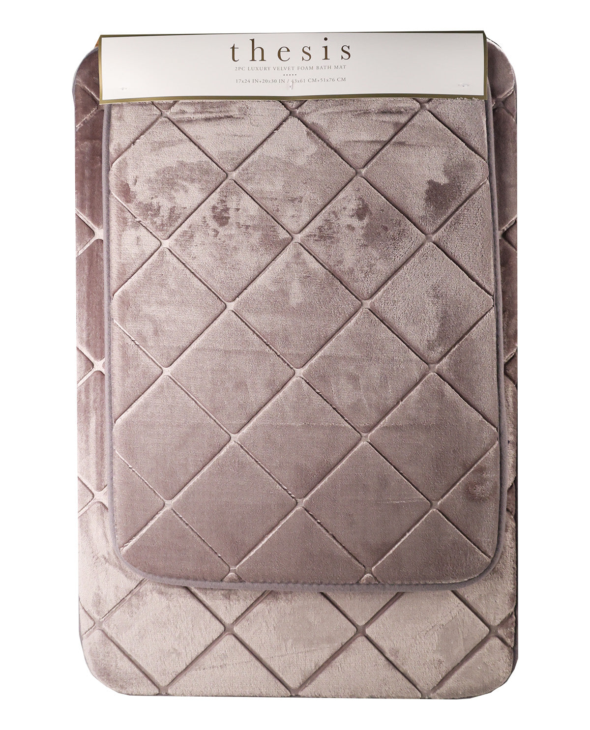 A dusty mauve quilted velvet blanket with a diamond pattern, folded inside its white paper packaging sleeve. The brand name 'thesis' is printed on the sleeve.