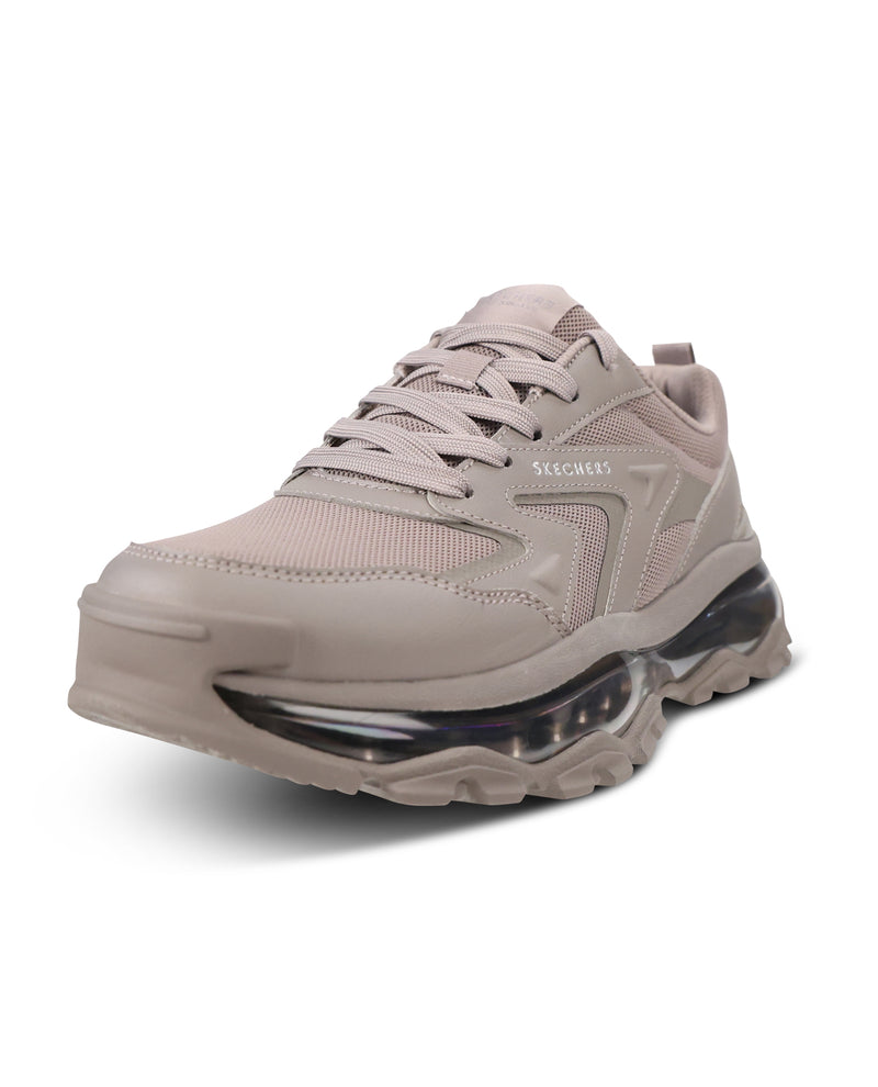 A single SKEGAWY sneaker in a light taupe-beige colorway, featuring a chunky platform sole with a visible clear air cushion unit, on a white background.