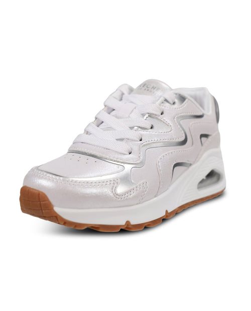 A low-top athletic sneaker in metallic silver and white, featuring a white lace-up closure, a white midsole with a visible air cushion unit, and a brown outsole.