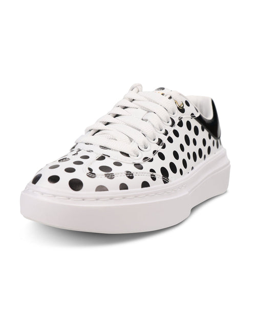 A white low-top platform sneaker featuring a black polka dot pattern across the upper, white laces, and a thick white platform sole.