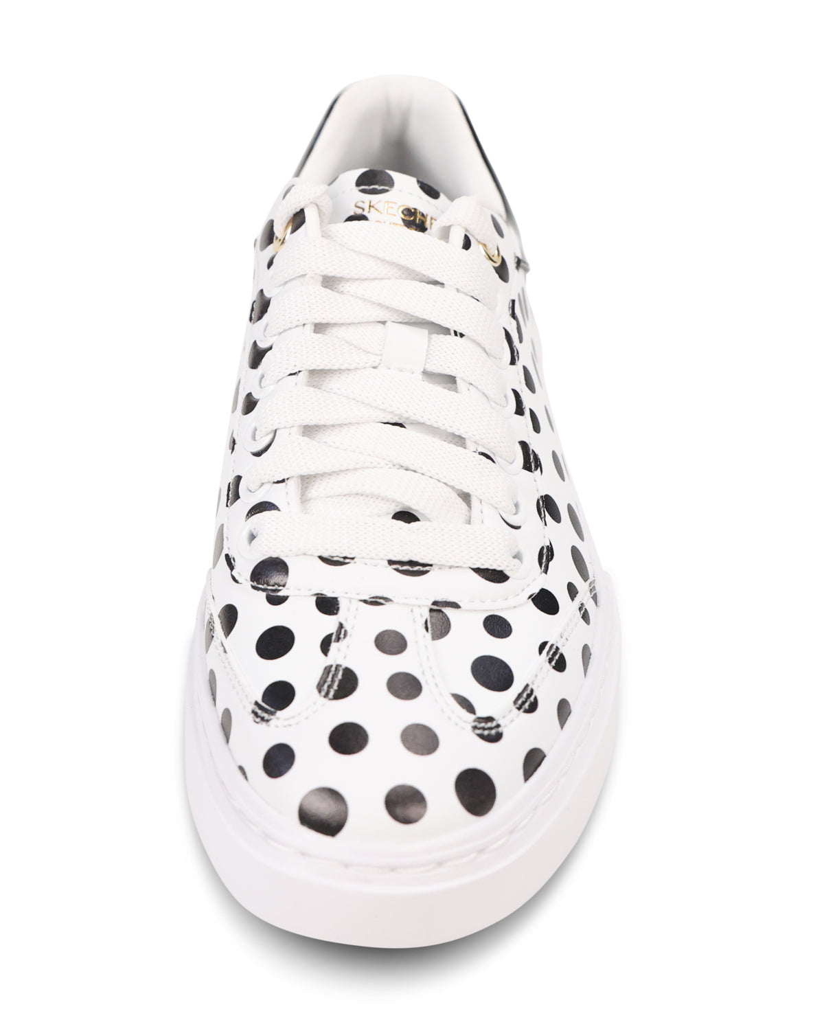 A white low-top sneaker featuring a pattern of large black polka dots across the upper, white laces, and a thick white sole, shown from a top-down perspective on a white background.