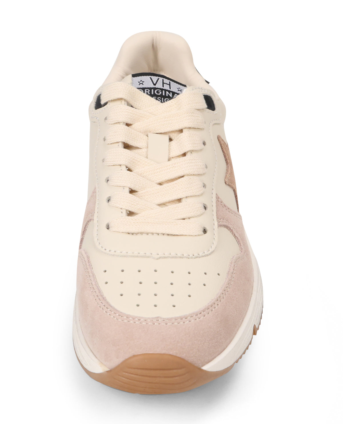 A low-top sneaker shown from a front-facing angle on a white background. The shoe features cream-colored leather and suede panels, matching cream laces, a light pink suede overlay on the toe box, and a brown gum outsole.