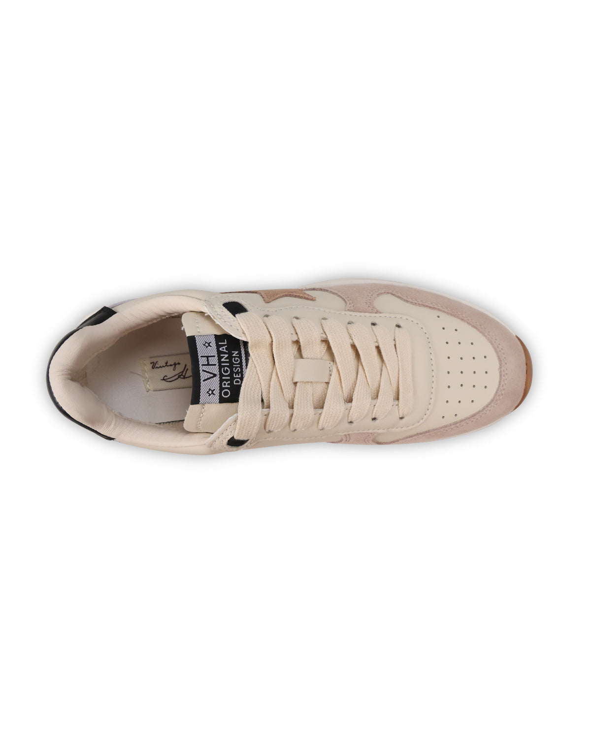 A top-down view of a low-top sneaker in cream and light tan, featuring matching cream laces and a black and white brand label on the tongue.