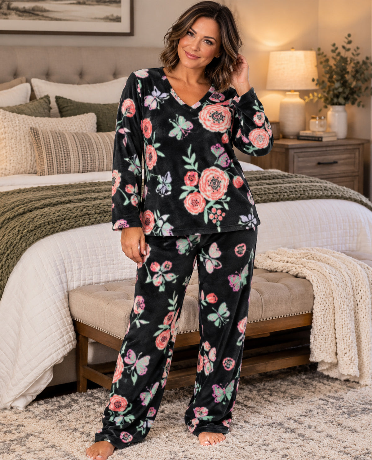 Missy model wearing a black floral long sleeve pj set with a bedroom background