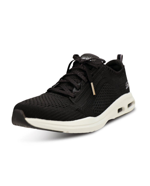 A black knit athletic sneaker with a thick, chunky off-white midsole and a small gold accent near the laces, shown from a three-quarters angle on a white background.