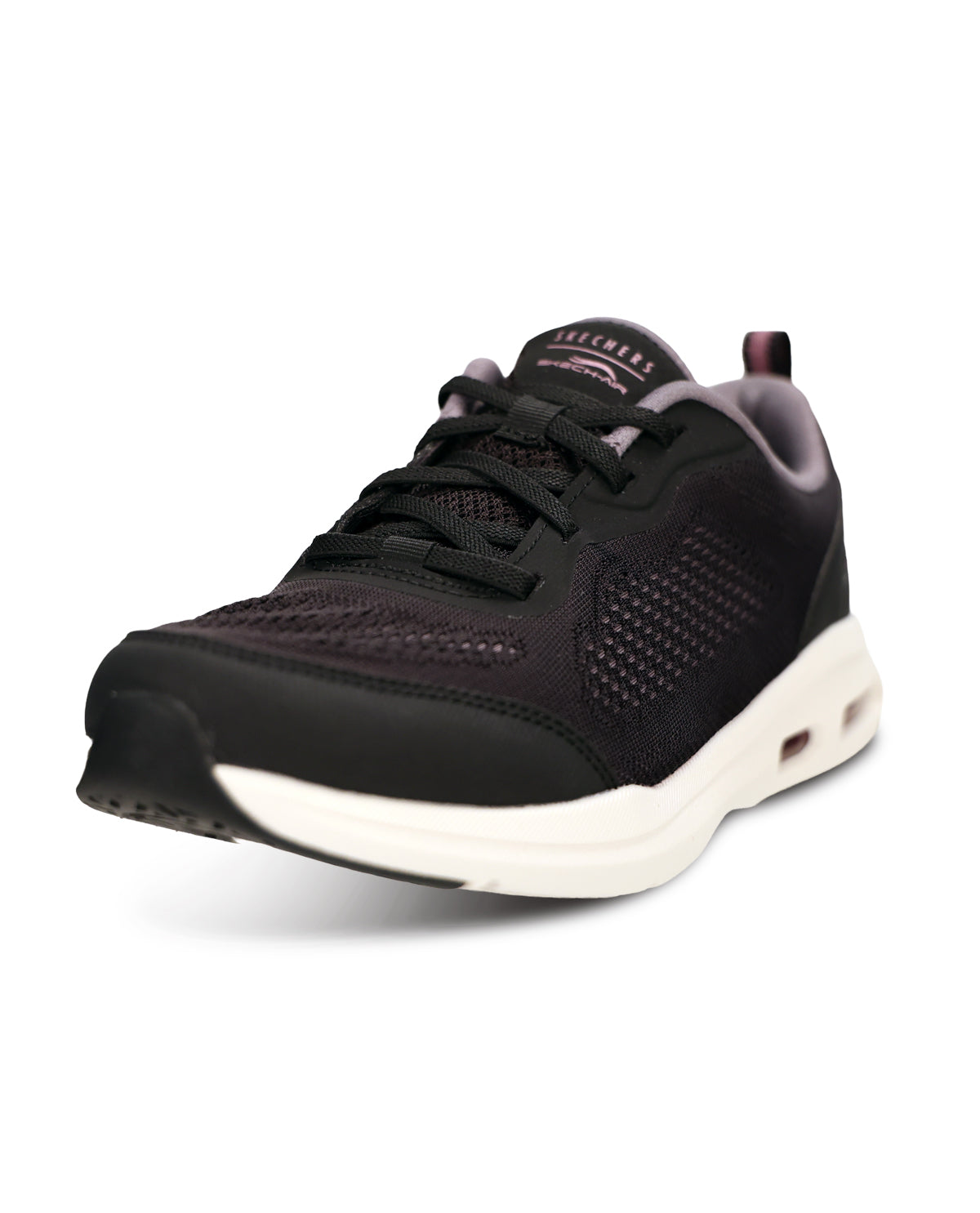 A black athletic sneaker with a white midsole and subtle pink accents on the tongue and heel, shown from a three-quarters angle on a white background.