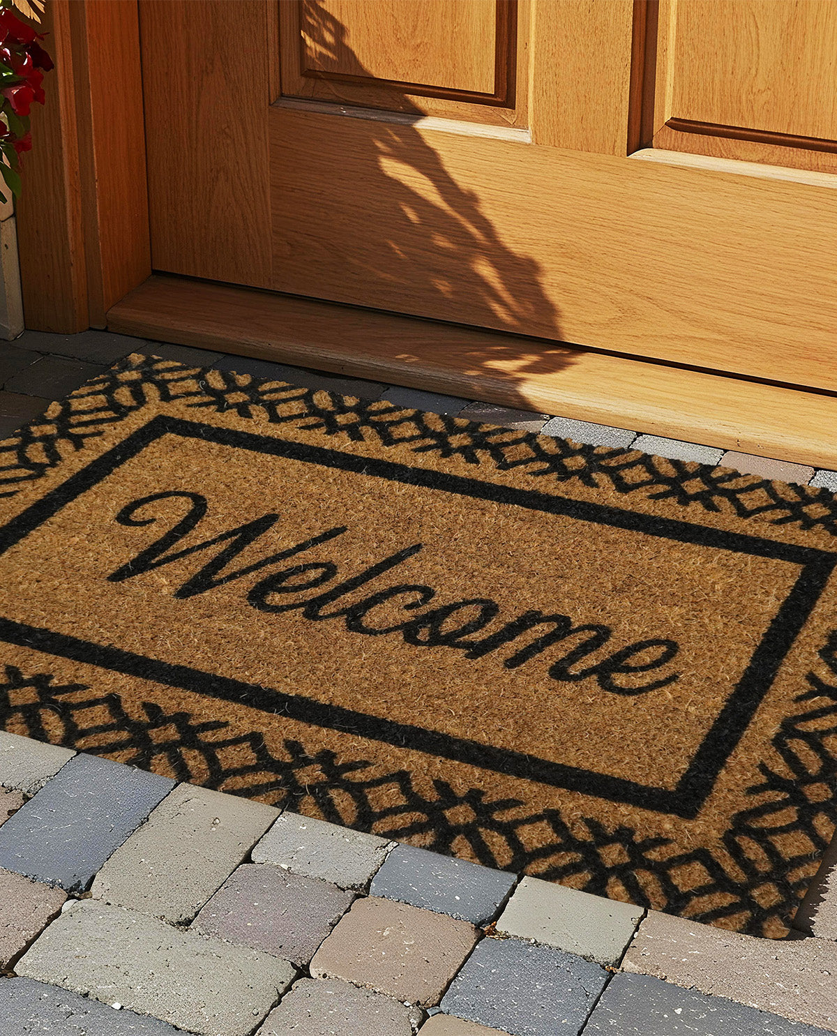Doormat with 'Welcome' text in front of a wooden door.
