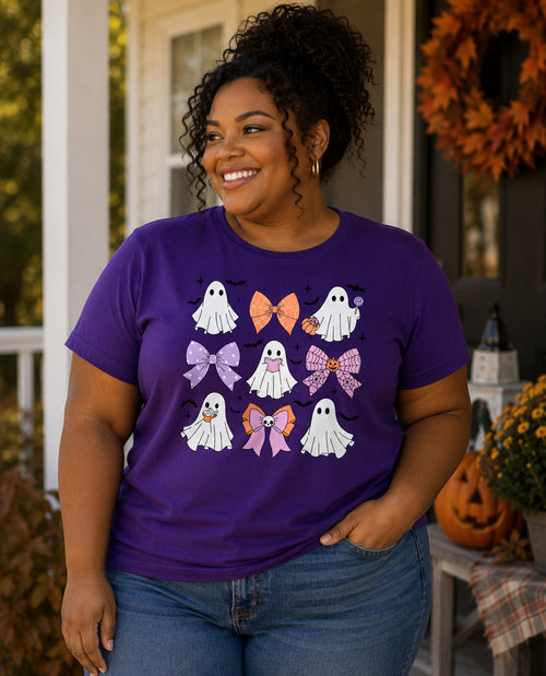 Woman wearing a purple t-shirt with Halloween-themed designs, standing outdoors.