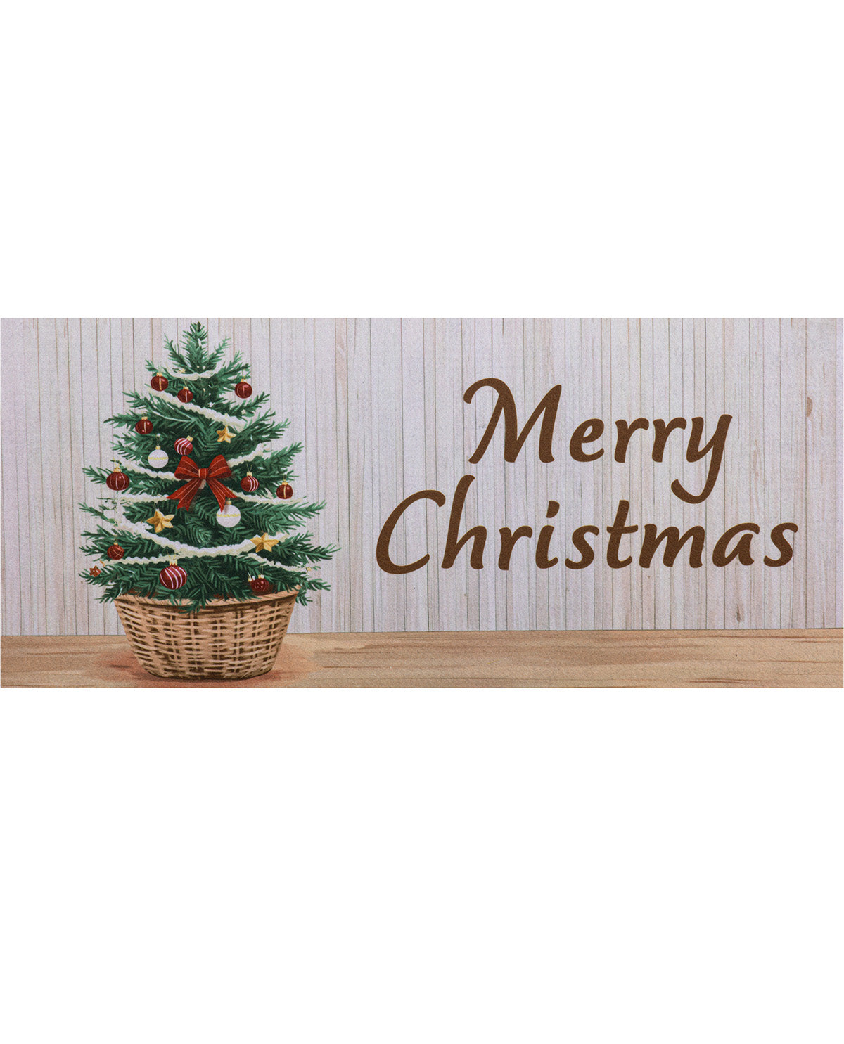 A rectangular holiday sign or print featuring a small decorated Christmas tree in a wicker basket on the left and the words “Merry Christmas” in brown script on the right, set against a light wood-plank background.