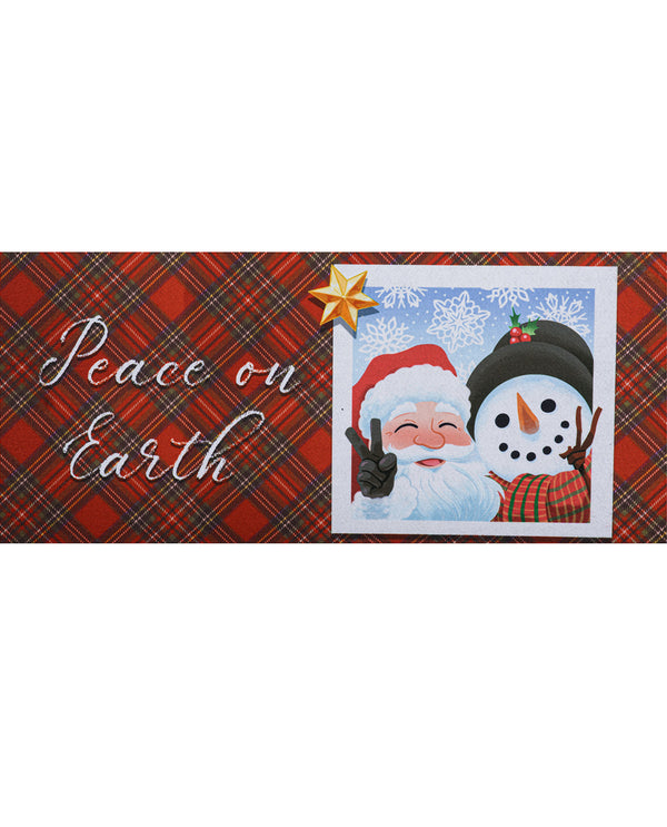 A rectangular Christmas-themed decorative sign or banner with a red plaid background, the phrase 'Peace on Earth' in white script, and a central illustration of Santa Claus smiling beside a snowman under a gold star.