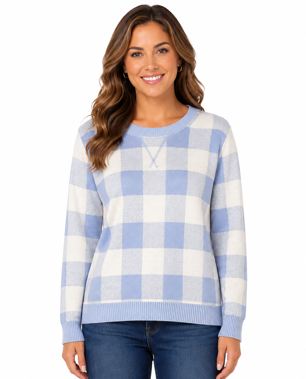 A woman wearing a light blue and white gingham check crewneck sweater with blue jeans, photographed against a solid white background.
