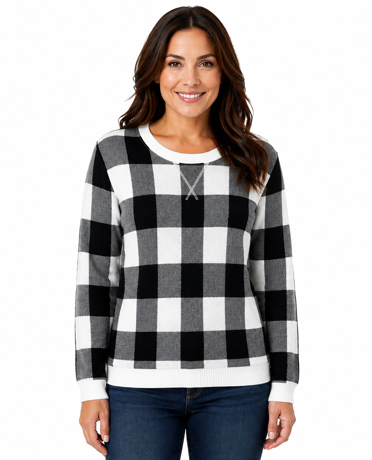A woman wearing a black and white buffalo check long-sleeve sweater with a crew neck, paired with dark blue jeans, against a plain white background.