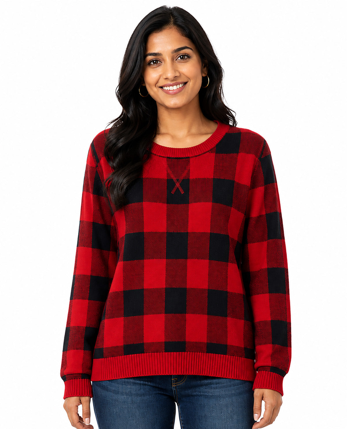 A woman wearing a red and black buffalo plaid crewneck sweater with a small embroidered red 'X' on the chest, paired with blue jeans, against a plain white background.