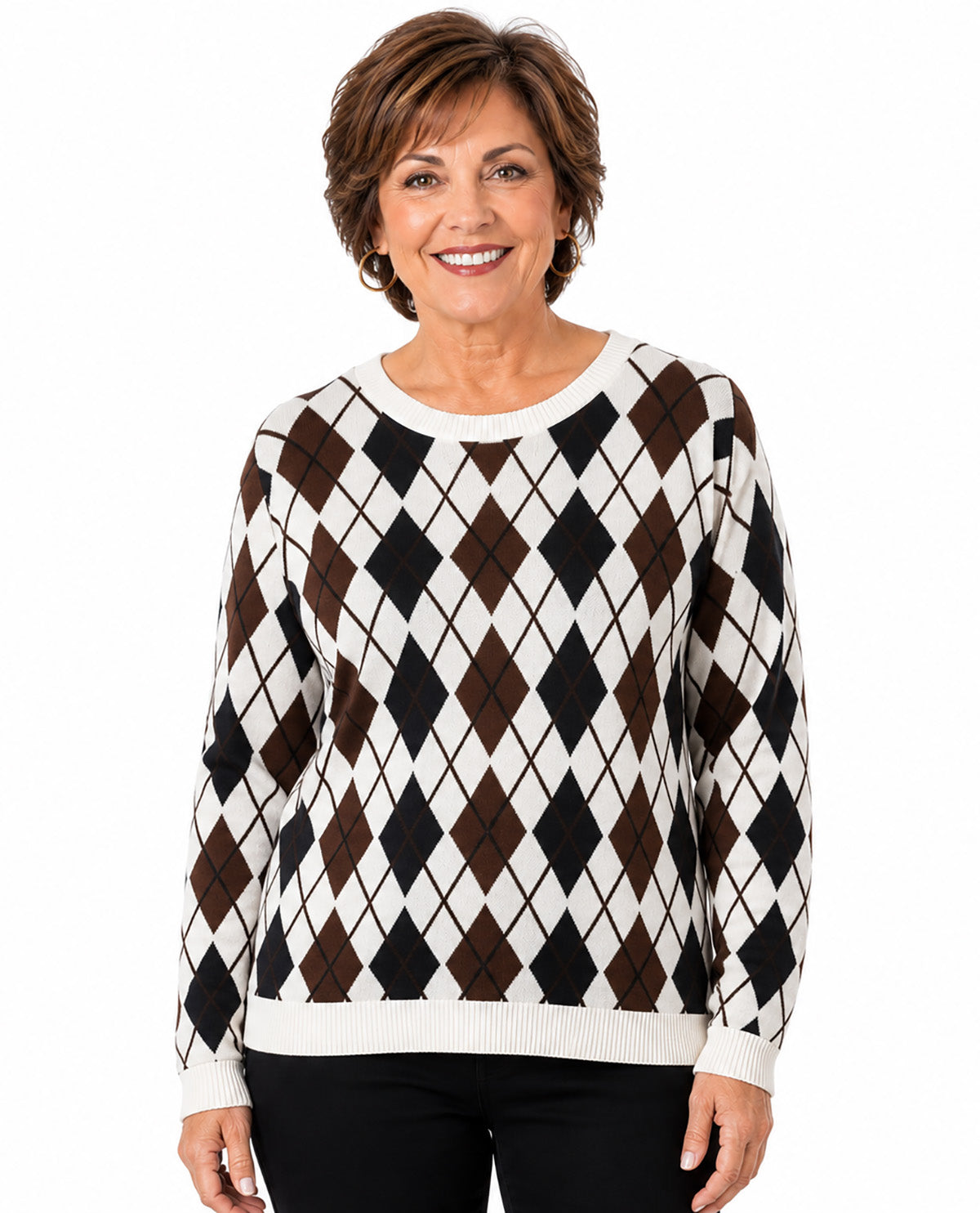 A woman wearing a long-sleeve knit sweater with a brown, black, and off-white argyle pattern, paired with black pants, against a plain white background.