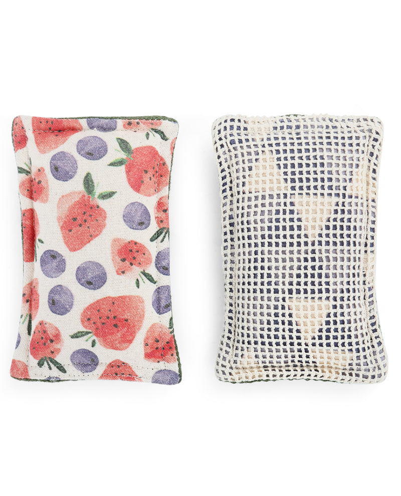 Two square decorative pillows shown side by side on a plain white background. The left pillow has a white base with a colorful print of strawberries, blueberries, and green leaves.