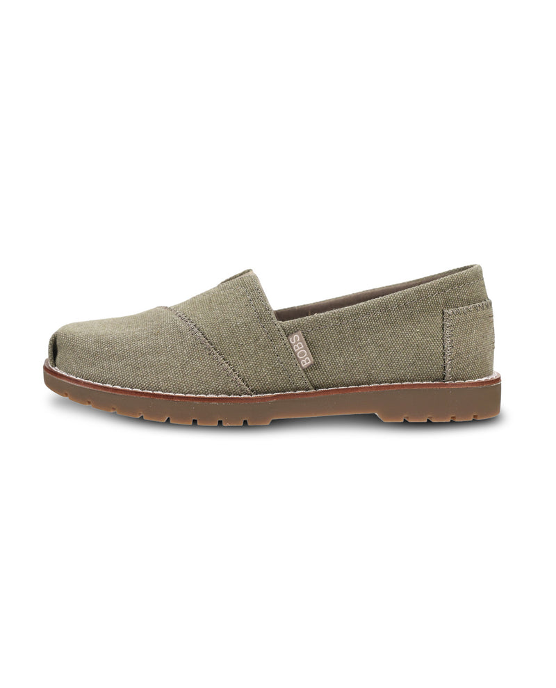 A single slip-on canvas shoe in a muted olive green color, featuring a brown sole and white contrast stitching, shown on a plain white background.