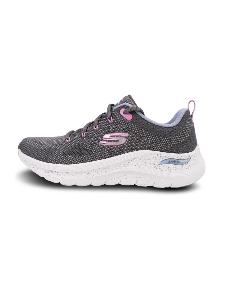 A Skechers athletic sneaker in dark gray mesh with pink accents on the laces, logo, and heel pull tab, featuring a white speckled cushioned sole.