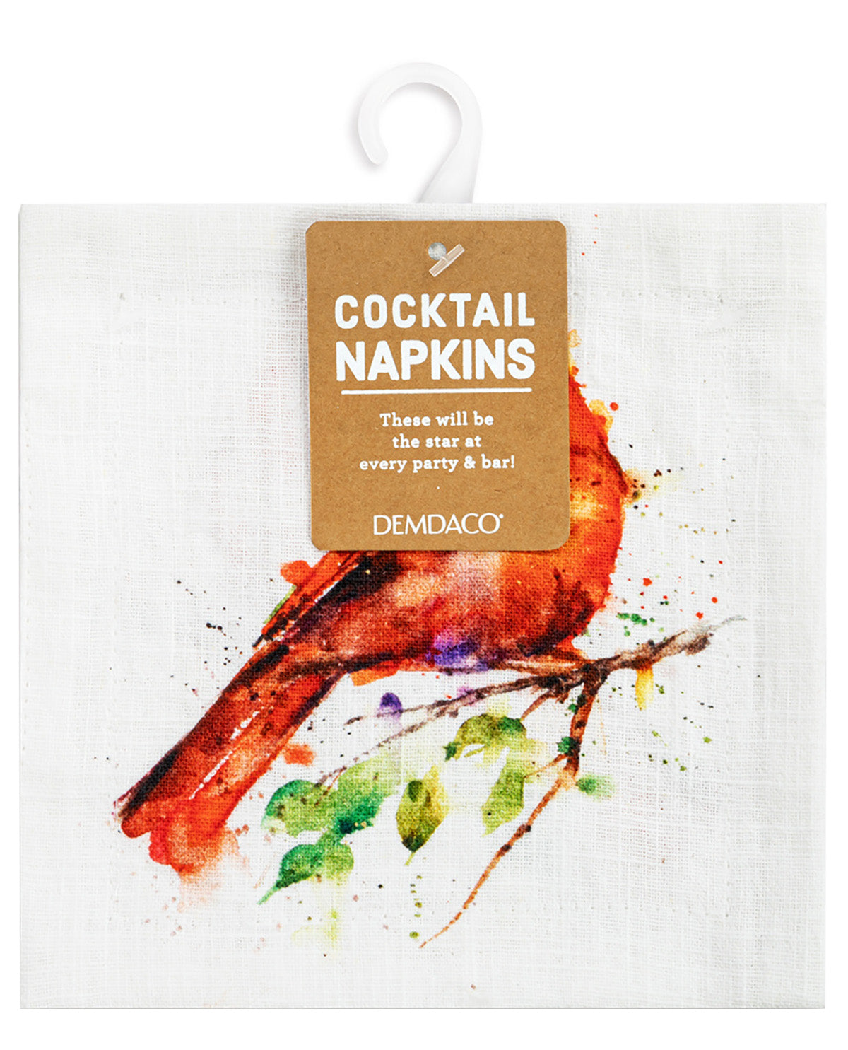 A white linen cocktail napkin featuring a watercolor-style red cardinal on a branch with green leaves, hanging from a white plastic hanger with a brown paper tag that reads 'COCKTAIL NAPKINS' and 'DEMDACO'.