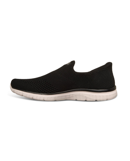 Black slip-on sneakers with white soles on a white background